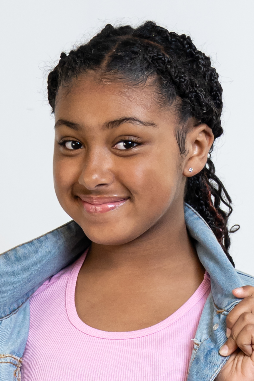 Eleaya Neveah, young actress and model, smiling headshot in a denim jacket over a pink top
